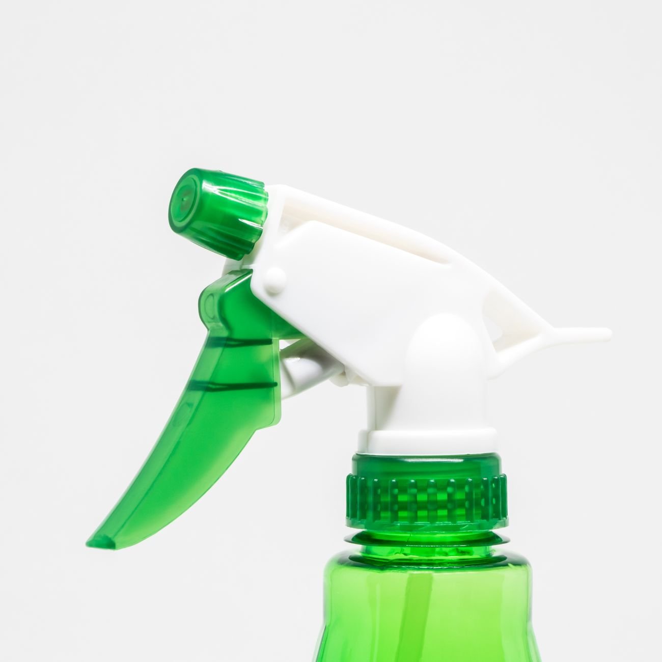 A spray bottle and cleaning cloth on a bathroom counter
