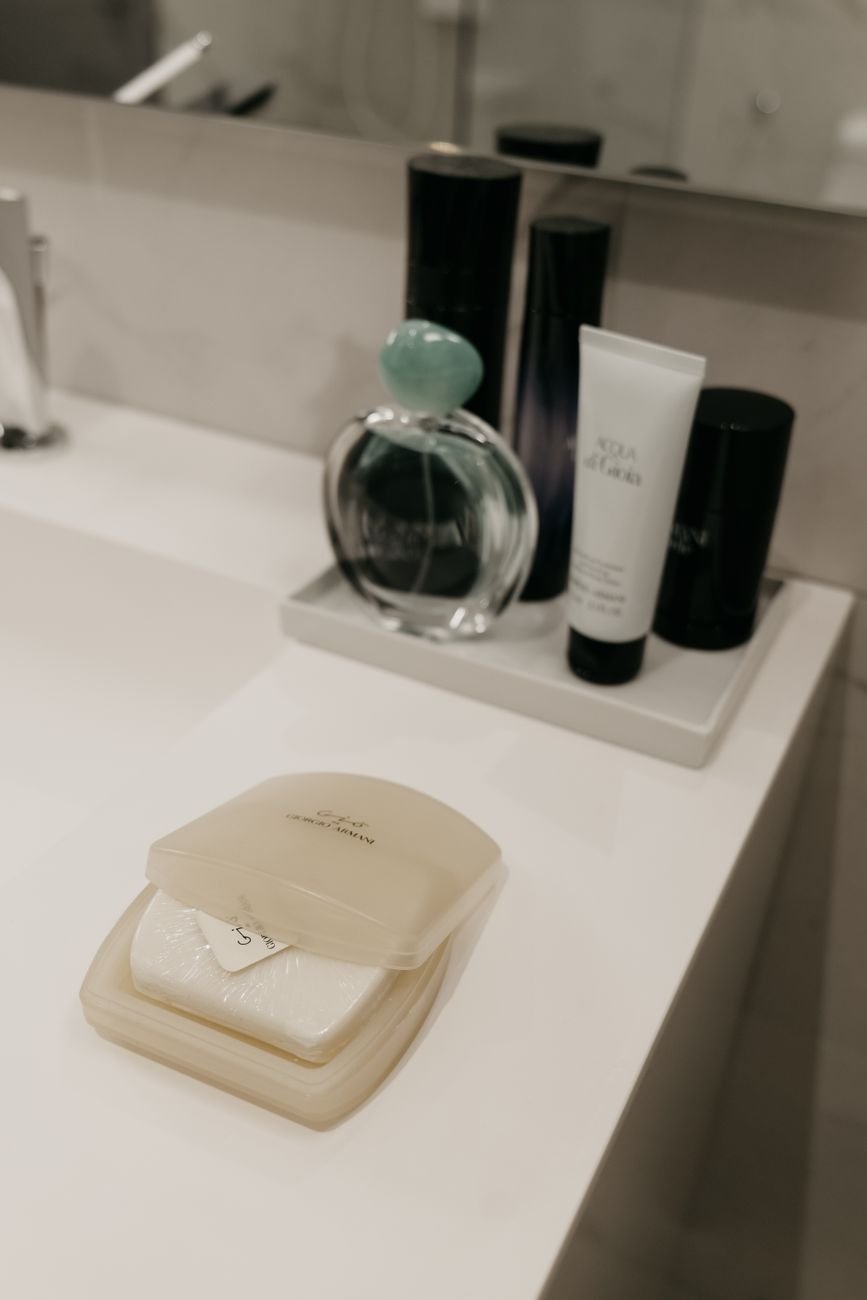 Bathroom products and bottles crowded on a counter