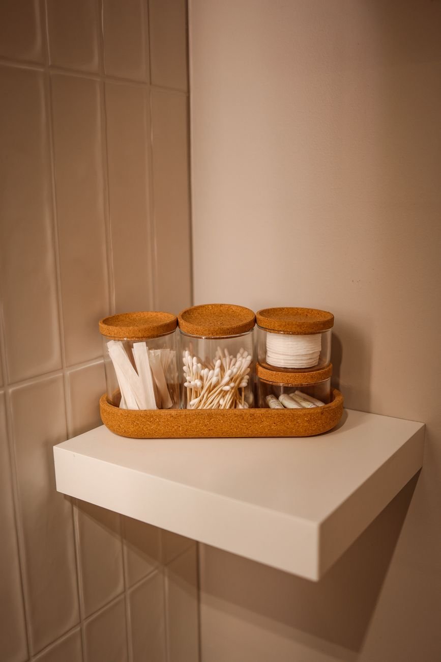 Clear containers holding cotton pads and small items