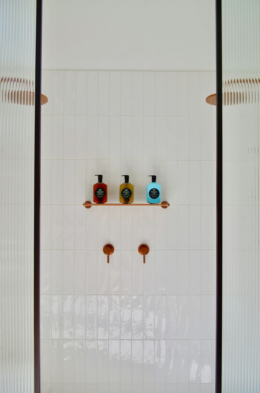 Shampoo bottles on a shower shelf