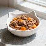 Soft beef mash for cats in a small white bowl