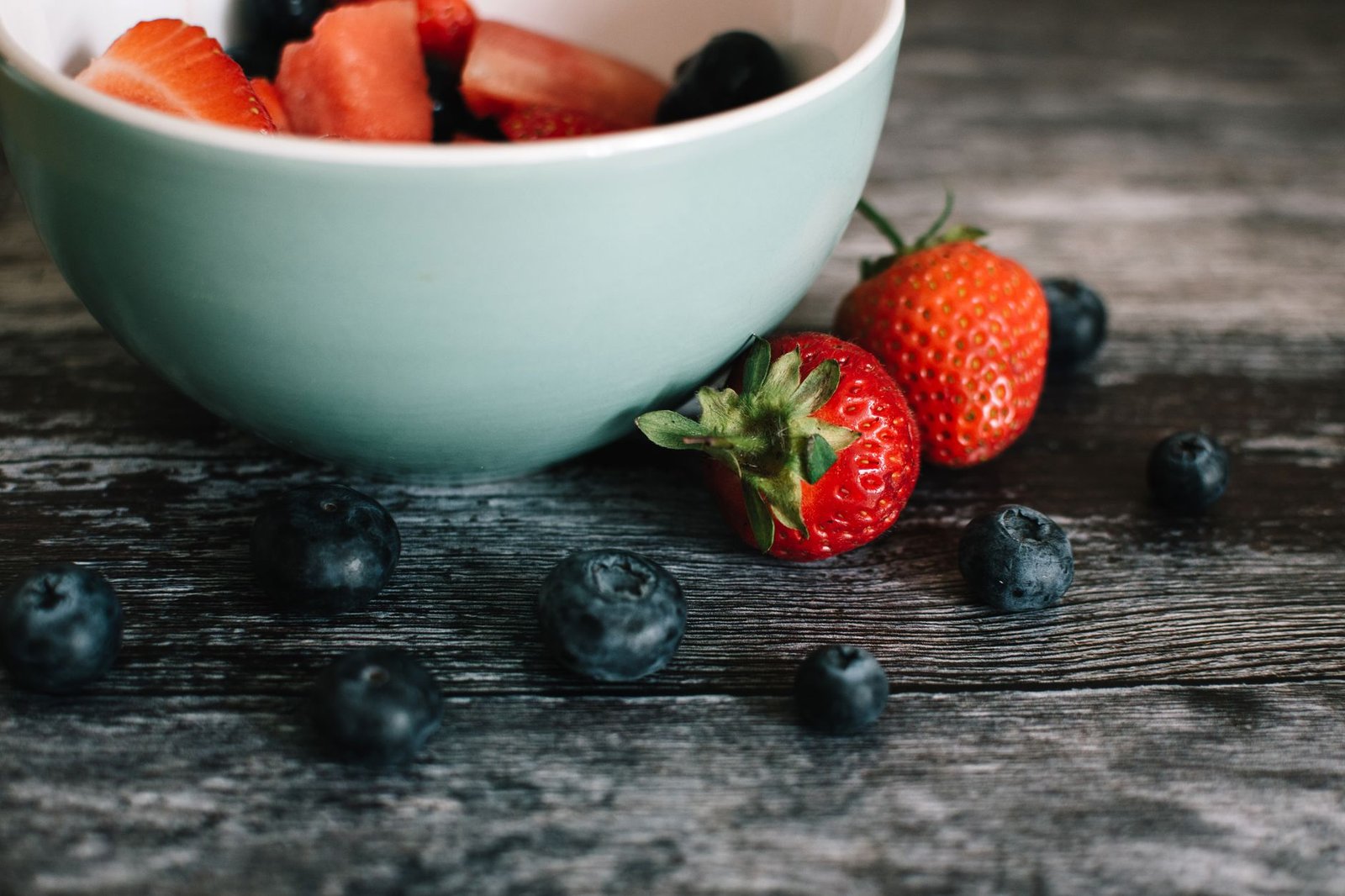 Fresh blueberries in a bowl on a wooden table