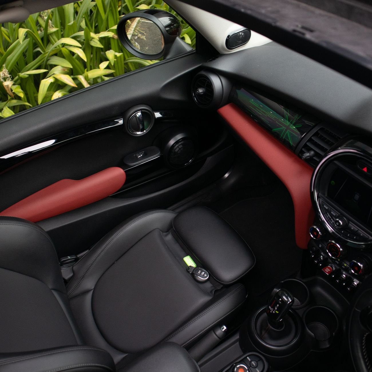 A hand vacuum cleaning a car seat