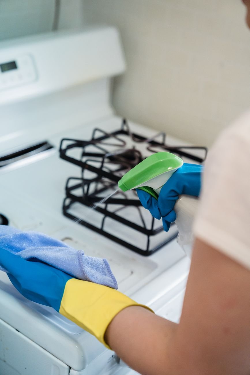 A woman wiping a kitchen counter