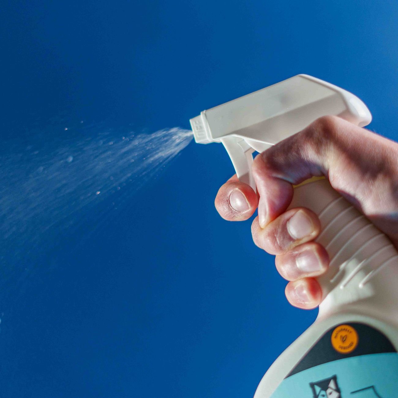 A cleaning caddy with spray bottles and cloths