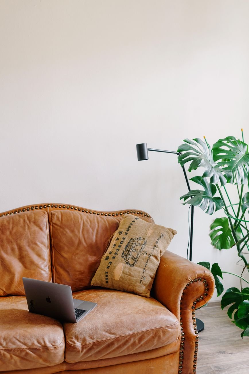 A brown leather couch in a living room