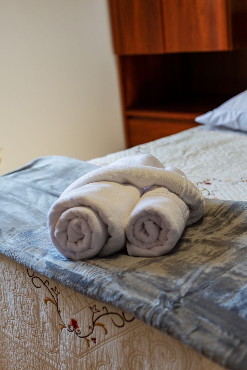 A neatly made bed in a bright bedroom