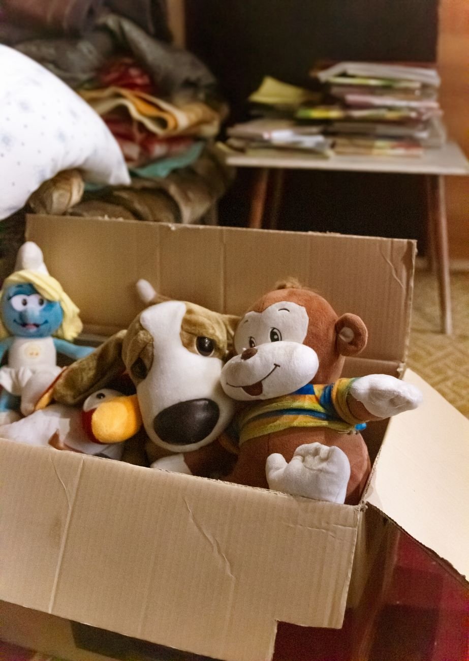A box of old plush toys ready to sort