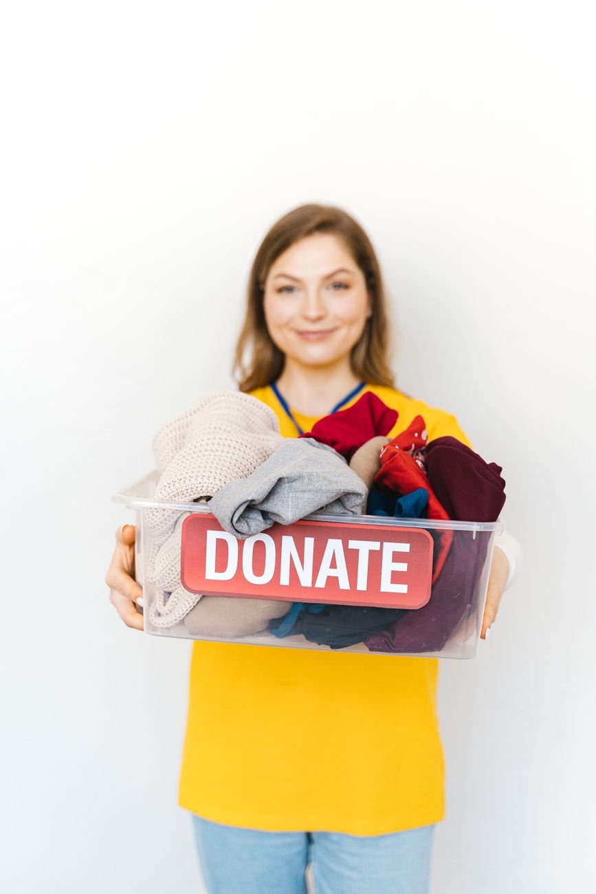 Folded blankets and towels in a donation box