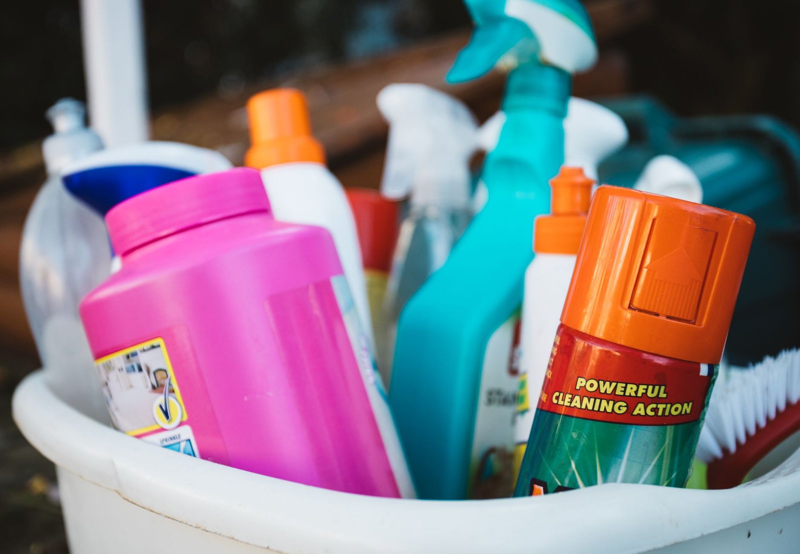 Cleaning supplies, gloves and a spray bottle ready for a deep clean in a bright home