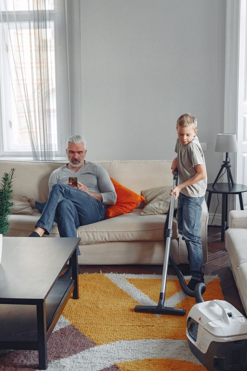 A vacuum cleaner on a living room rug