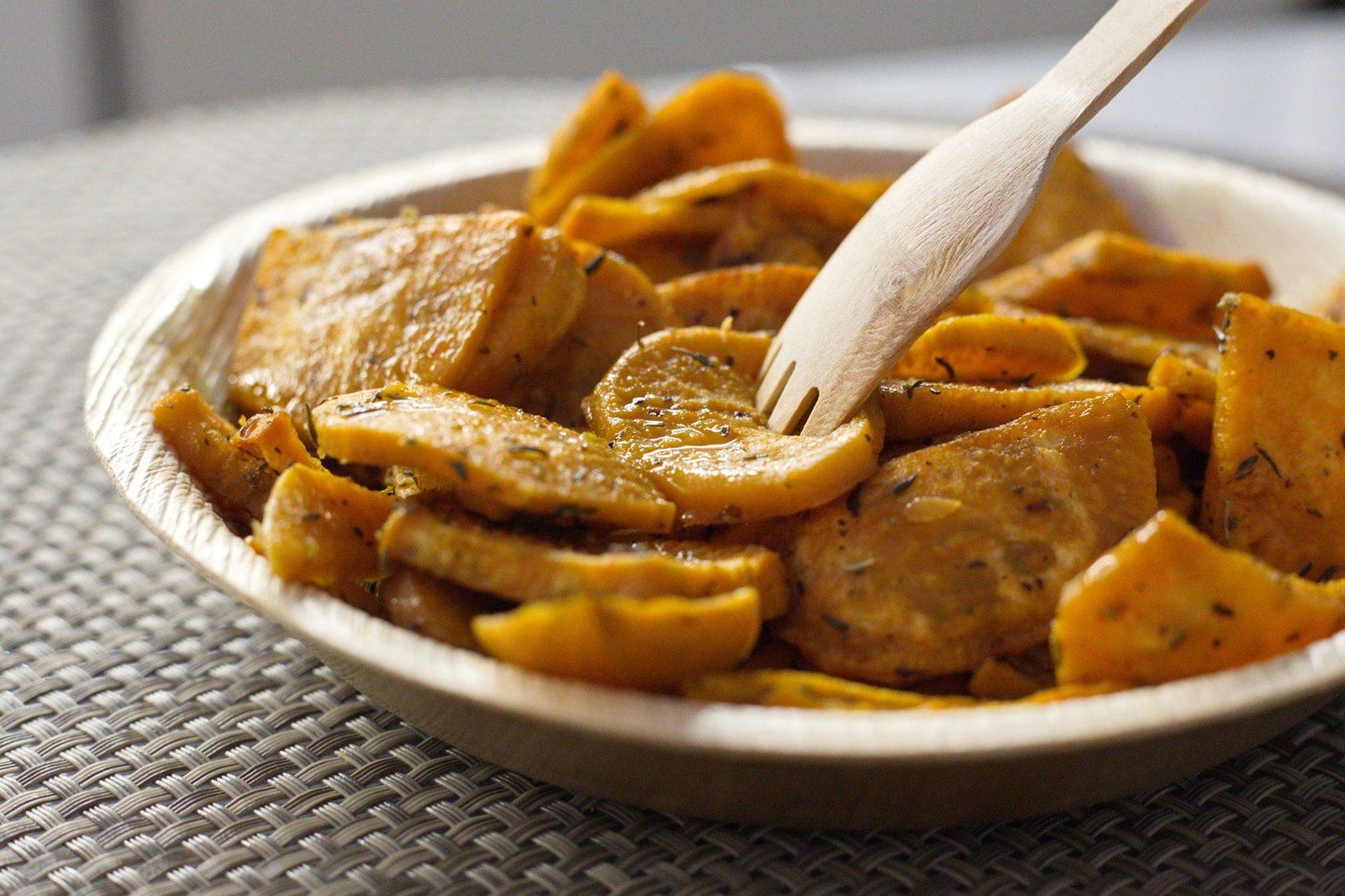 Golden dried sweet potato slices on a wooden board