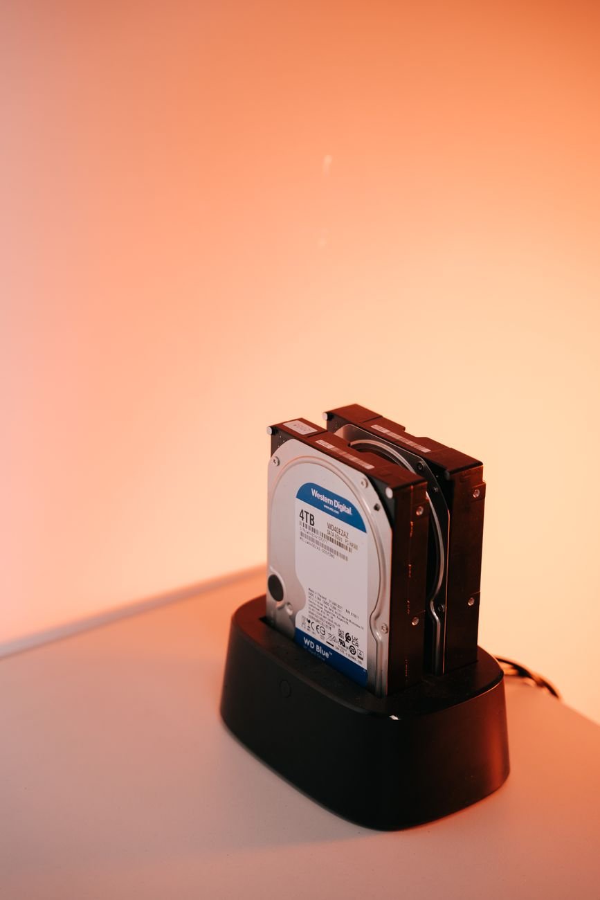 An external hard drive next to a laptop