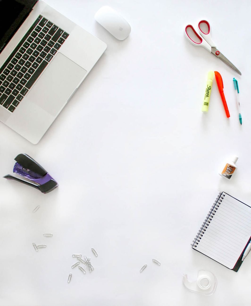Small items like pens, scissors and tape sorted on a table