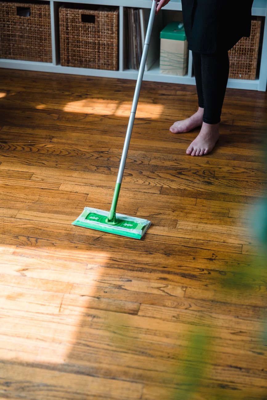 A microfiber mop cleaning a wood floor