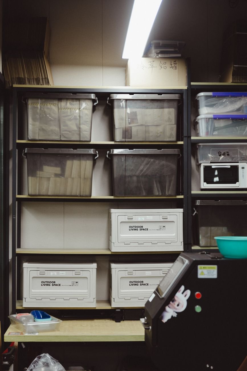 Plastic storage bins lined up on shelves