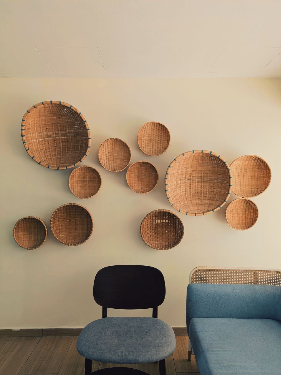 A living room shelf with woven storage baskets
