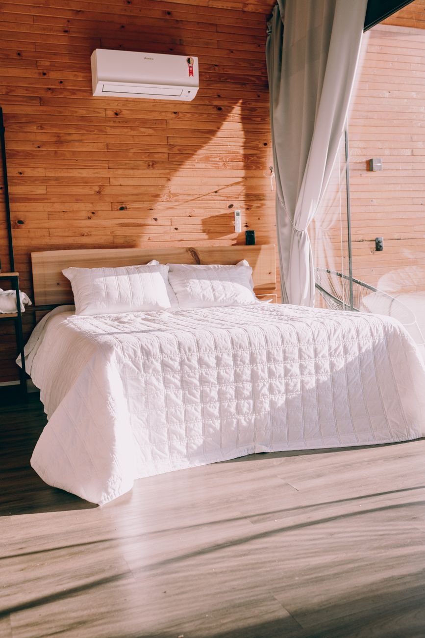 A neatly made bed in a calm, uncluttered bedroom