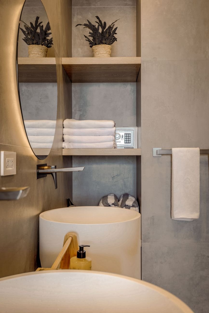 Folded towels and toiletries in a small bathroom