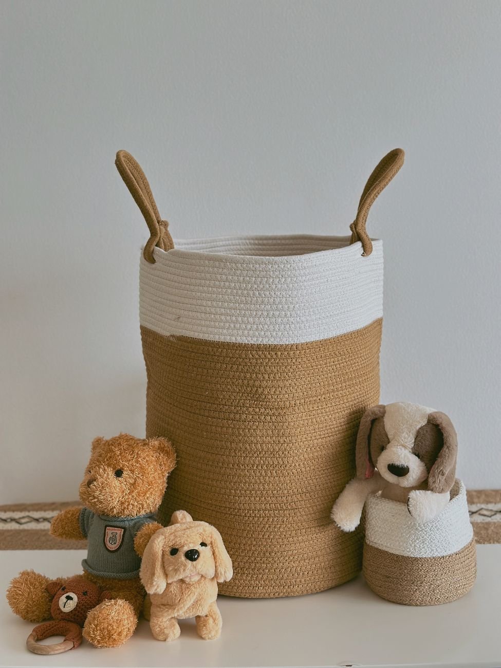 Toy baskets lined up on a low shelf