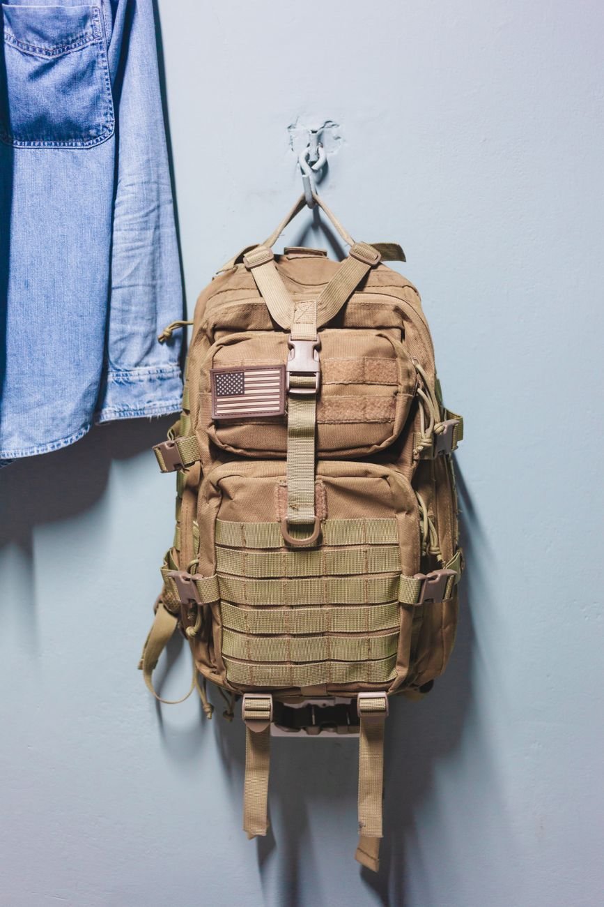 Backpacks and jackets hanging on hooks by the door