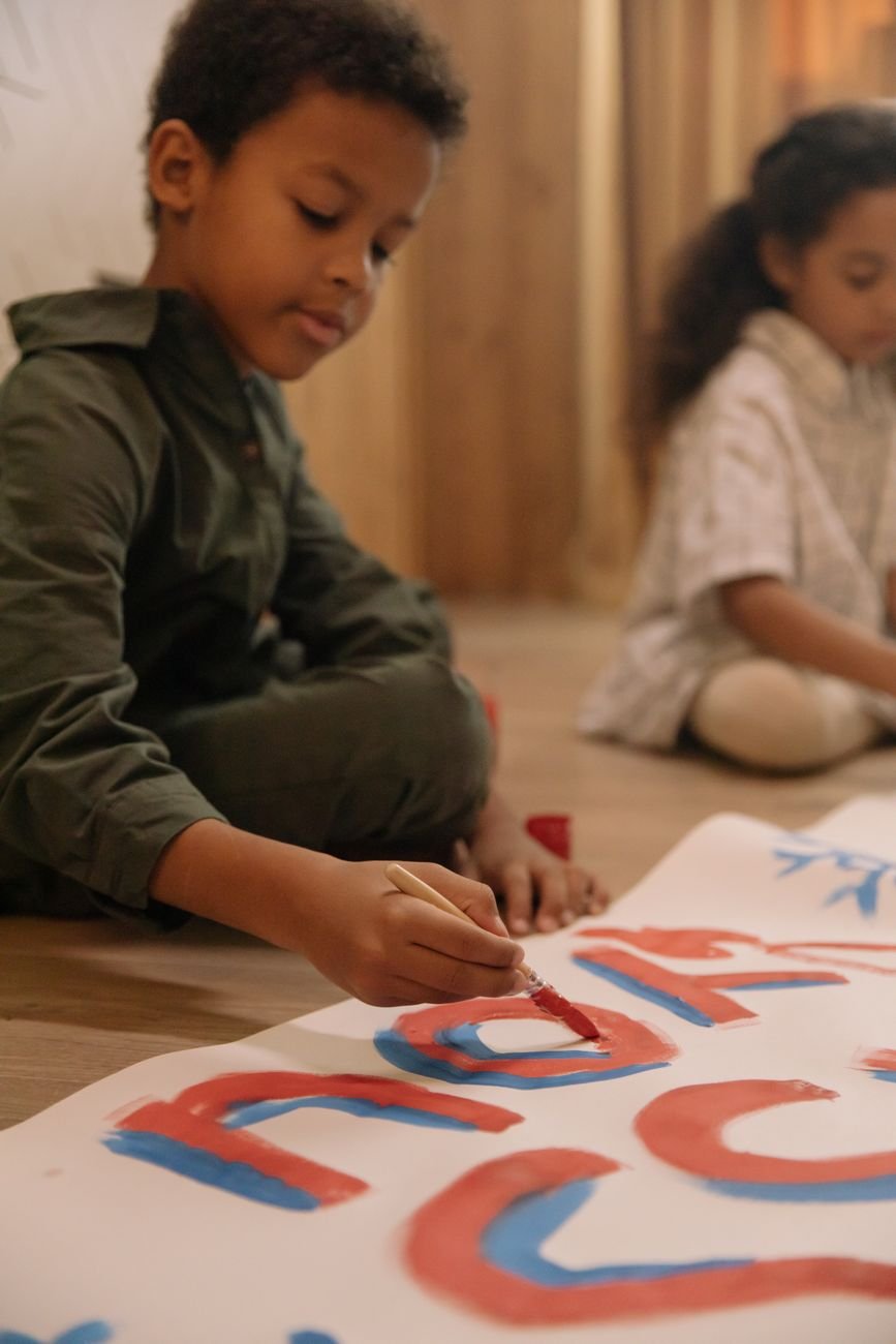 Children's drawings and art supplies on a table