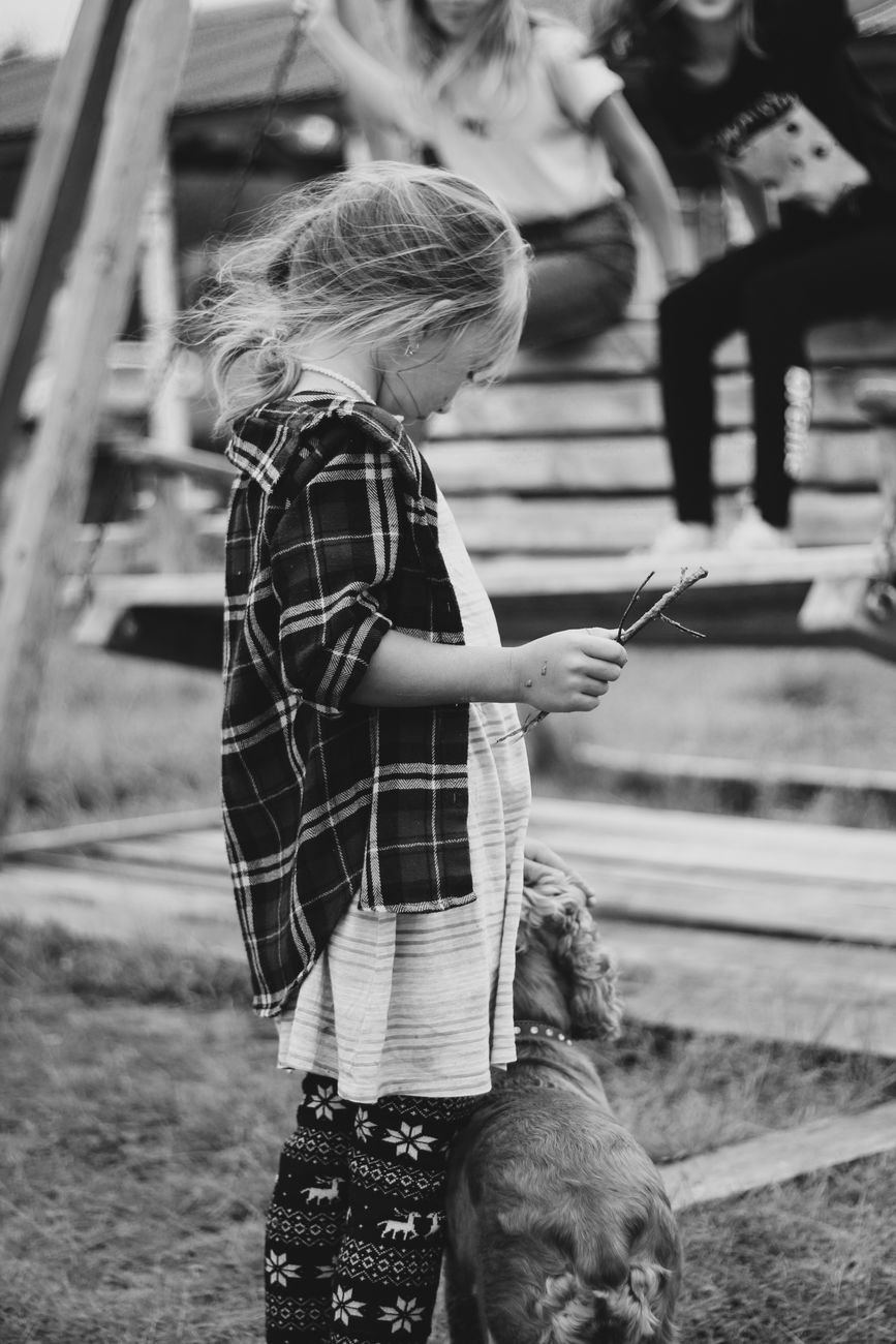 A child sitting on the floor with a dog