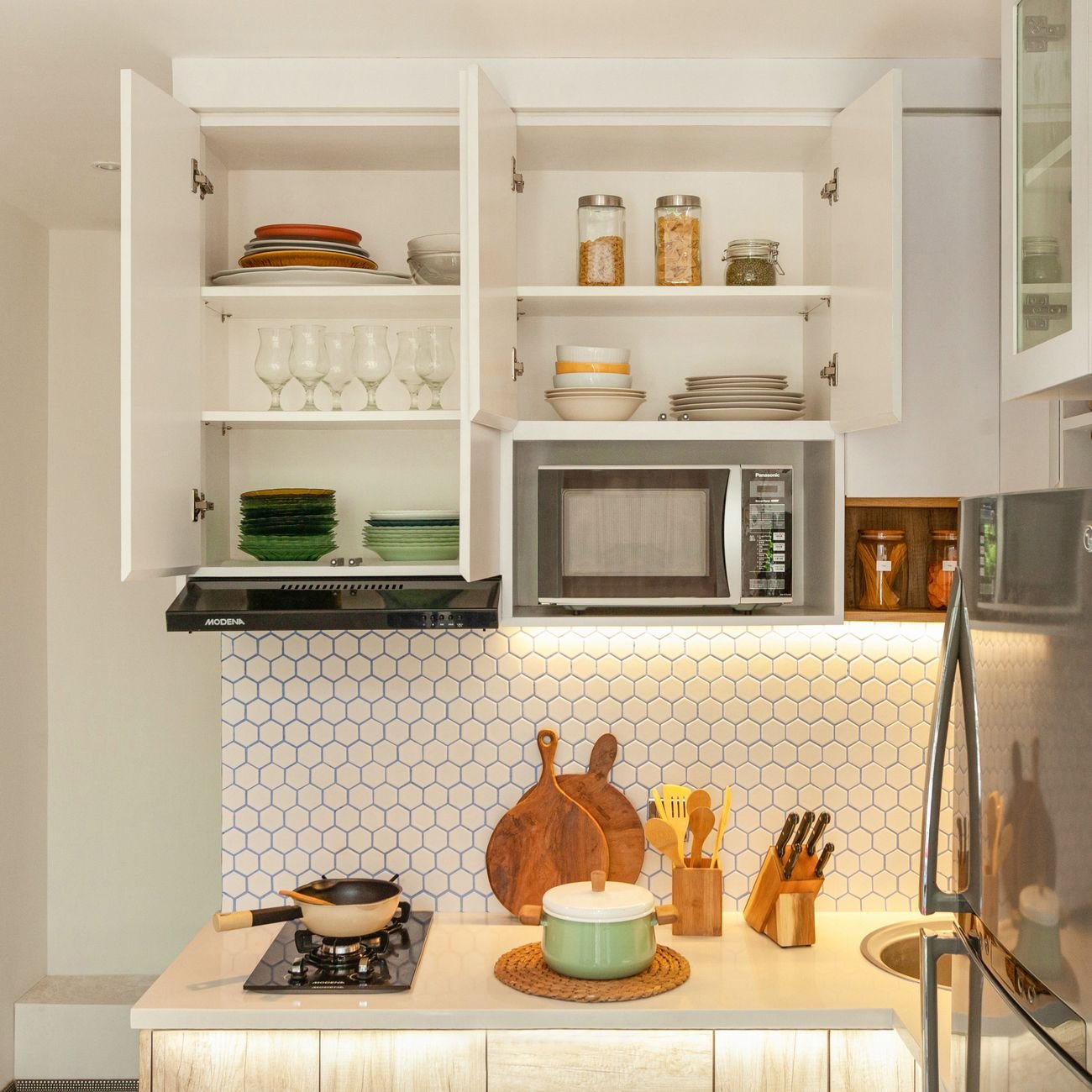 Kitchen counter covered with dishes and utensils during a clear-out