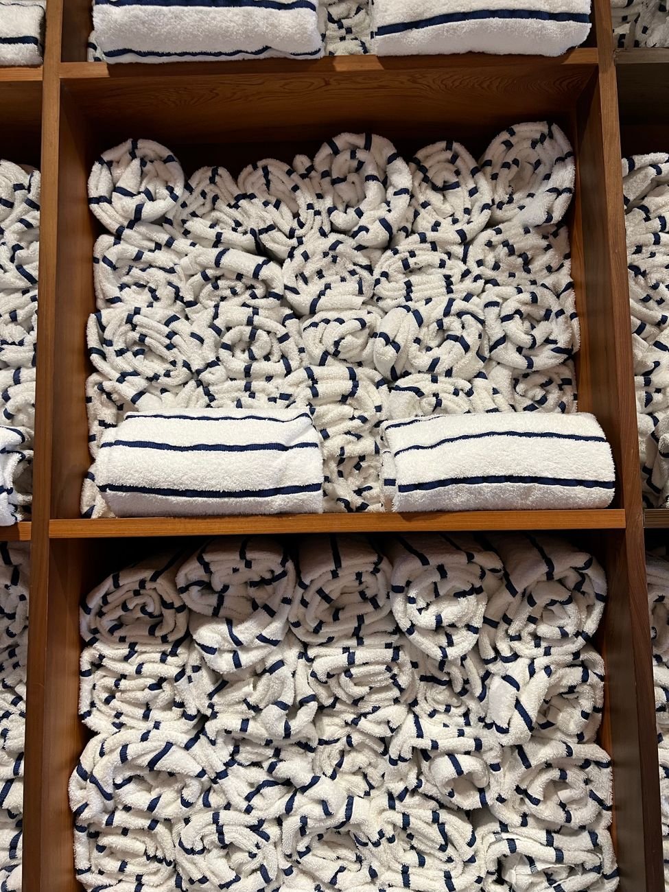 Folded towels stacked neatly on a shelf