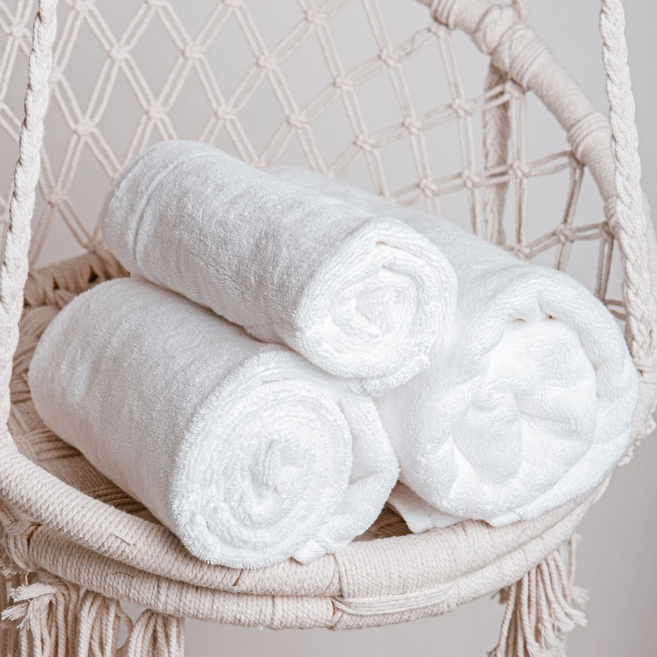 Rolled towels in a basket in a bathroom