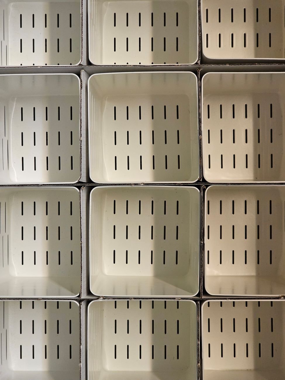 Stacked white storage bins