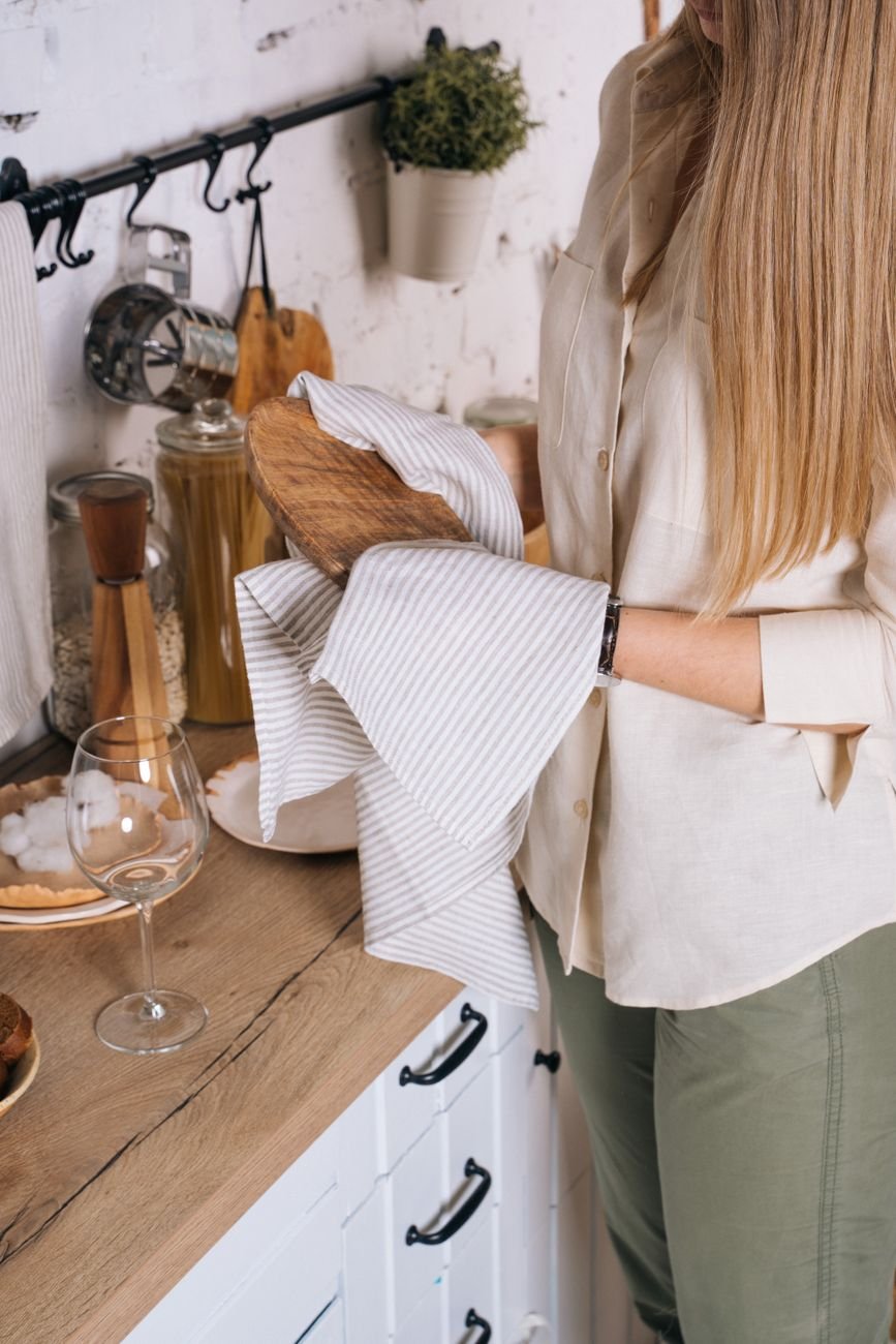 Wiping down a kitchen counter with a towel