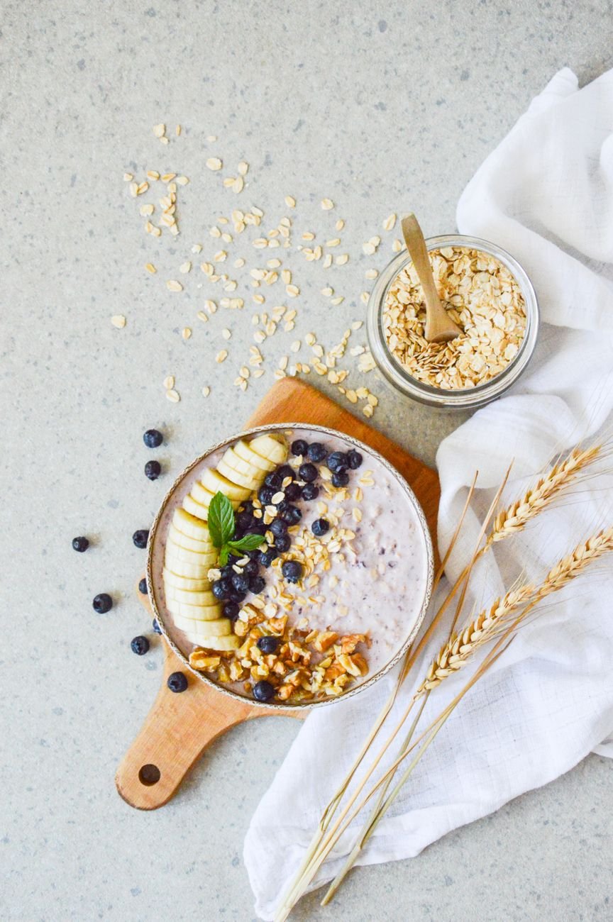 Rolled oats in a bowl on a wooden table