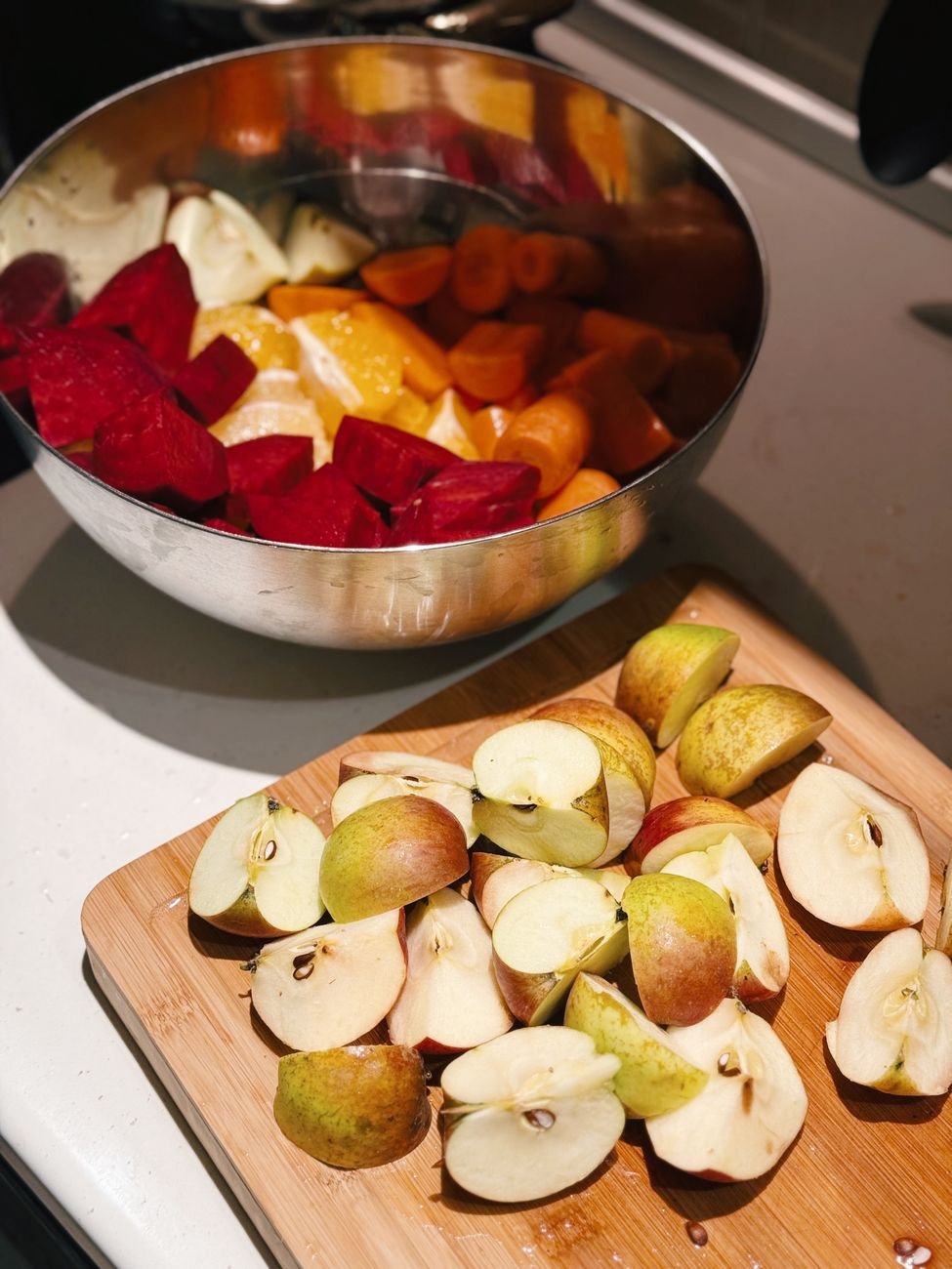 Sliced apples and carrots on a cutting board