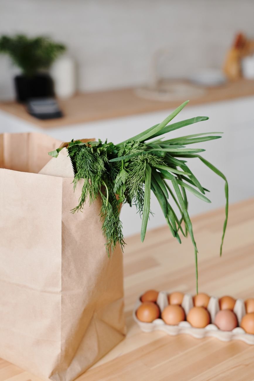 Groceries spread out on a kitchen counter being sorted