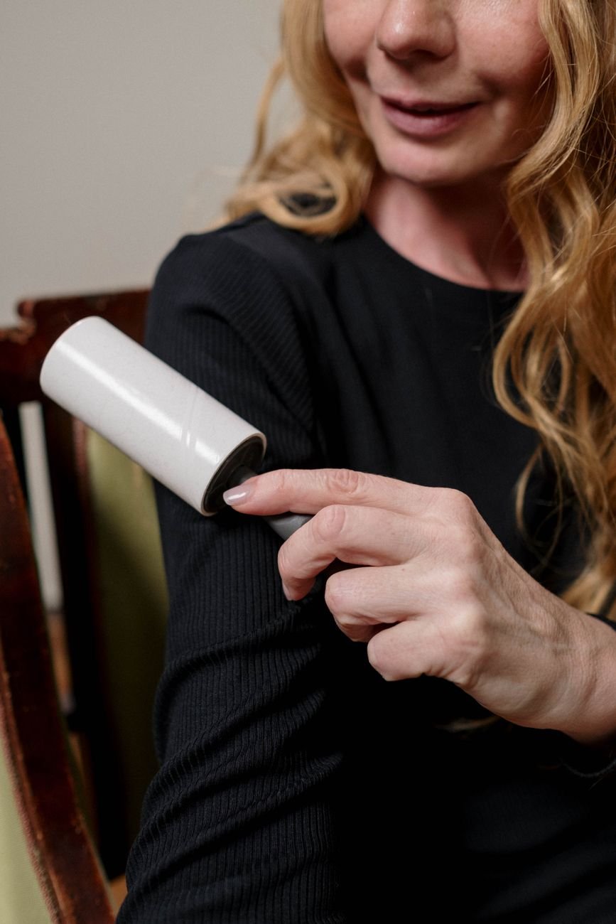 A lint roller on a dark sweater
