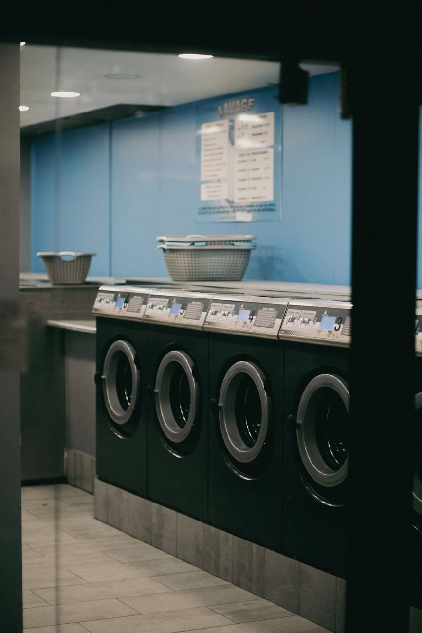 Laundry being loaded into a washing machine