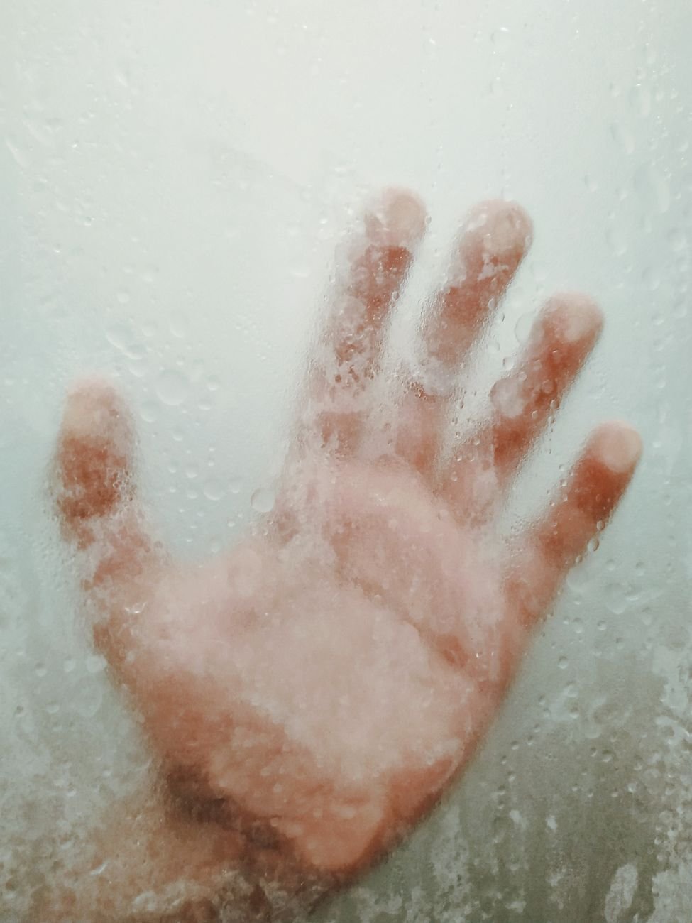 Water droplets and spots on a glass shower door
