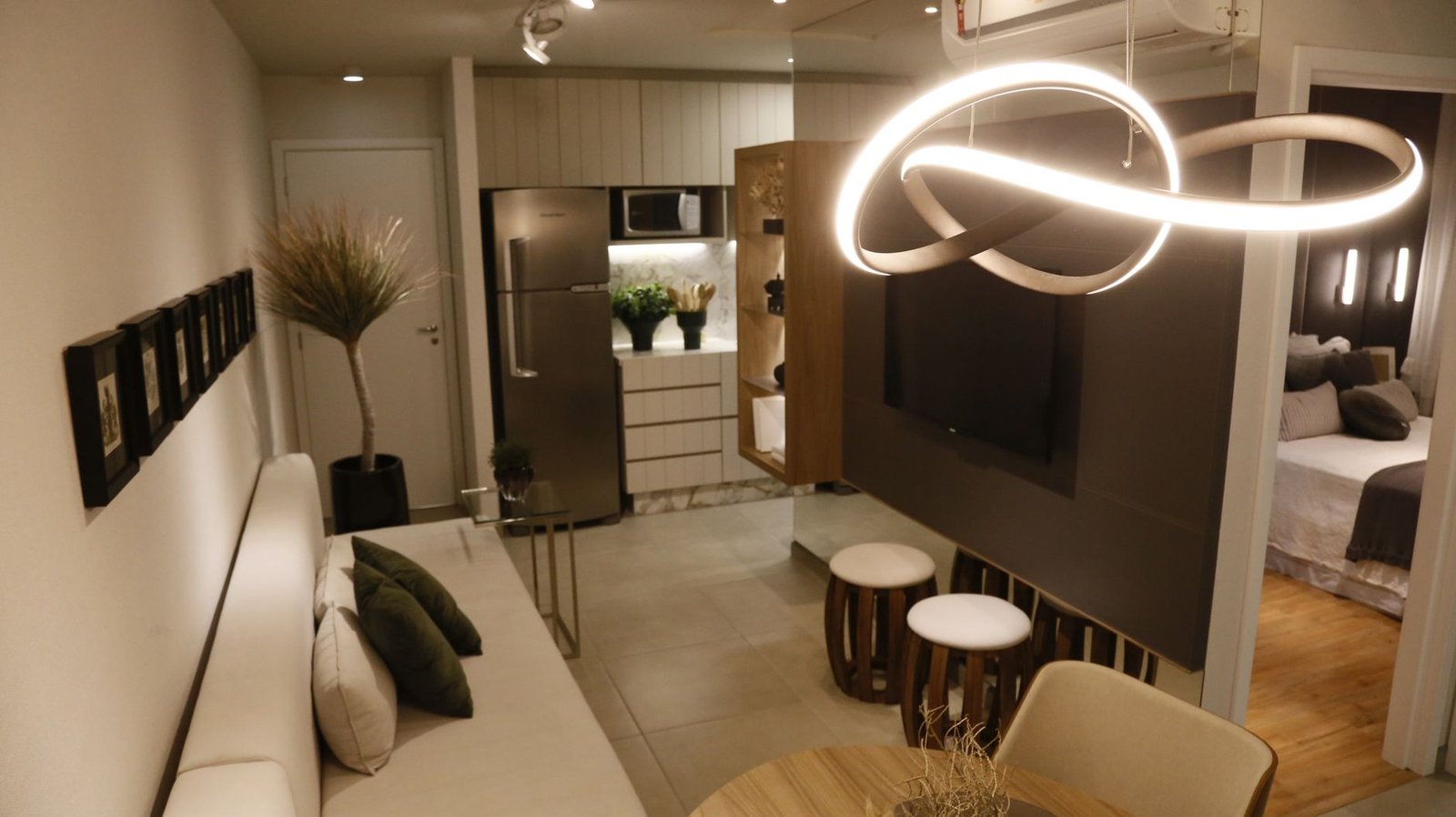 A bright, tidy small apartment living room with shelves and smart storage