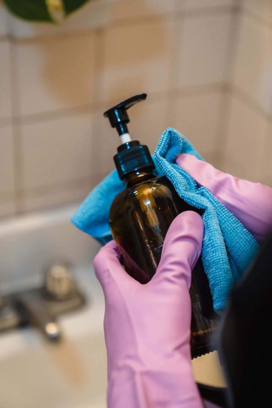 Wiping a bathroom surface with a cloth