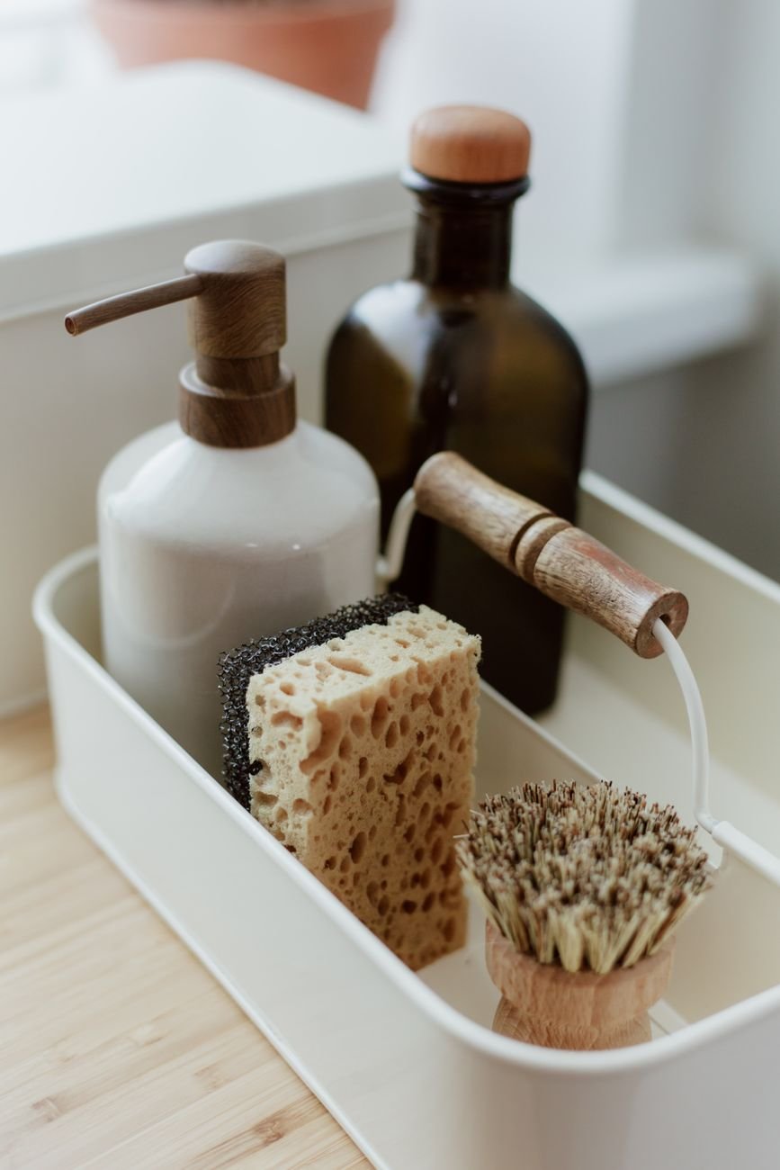 A caddy holding cleaning bottles and brushes