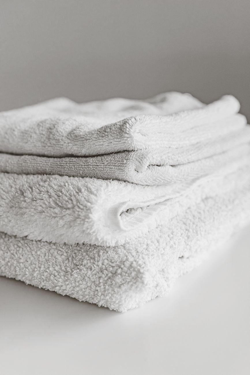 Fresh folded towels and bed sheets